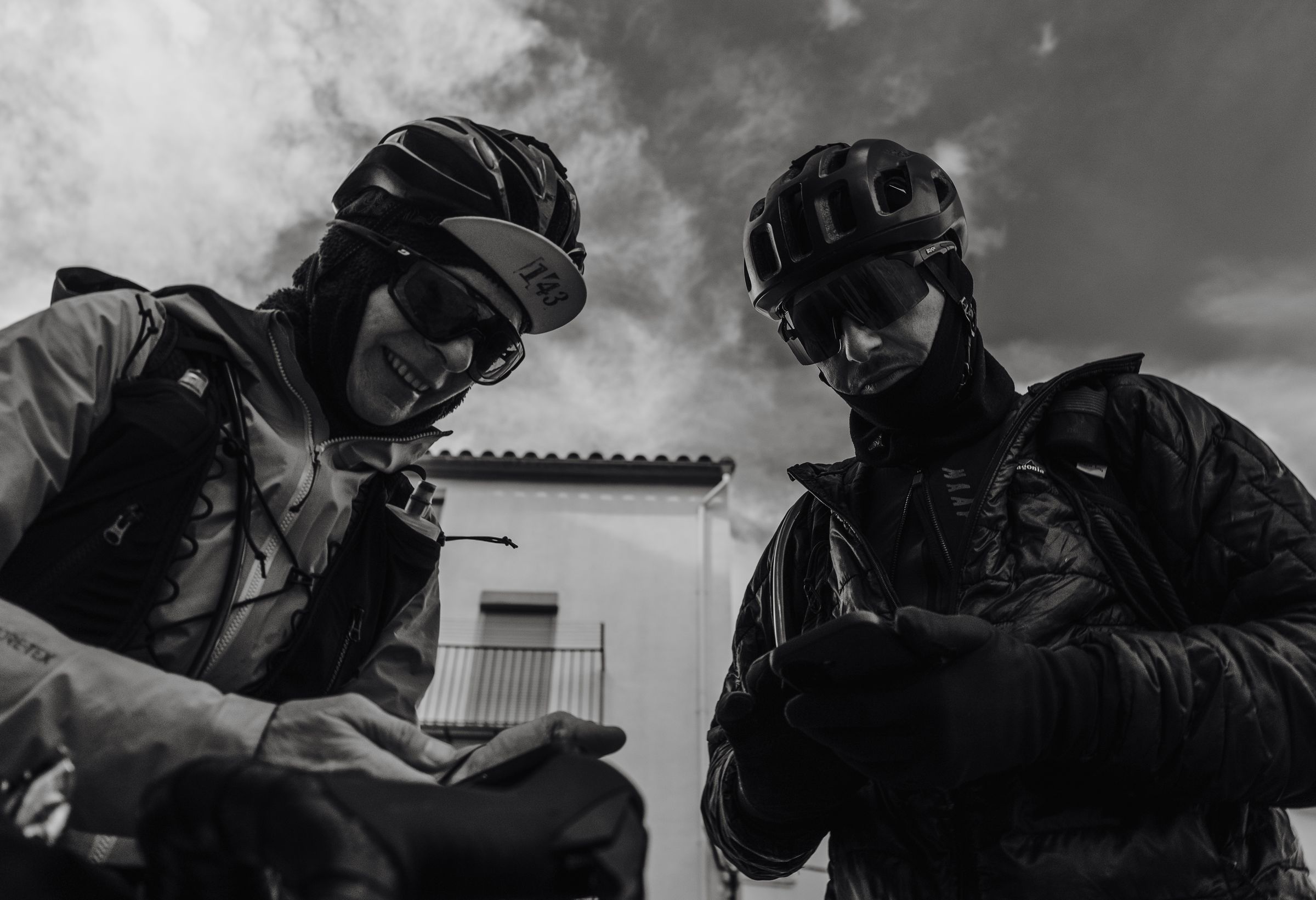 Two riders checking the coordinates of the next checkpoint on their phones